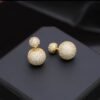2026/07/1000127380.jpg Boucles d'oreilles double face zircons dorées