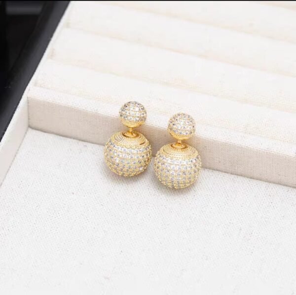 2026/07/1000127391-1.jpg Boucles d'oreilles double face zircons dorées