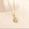 Parure ovale motif vague, ton or et blanc